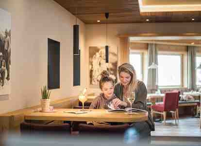 A woman and a child are sitting at a table