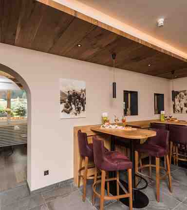 In the hotel bar of Hotel Waldheim, an aperitif is placed on the table