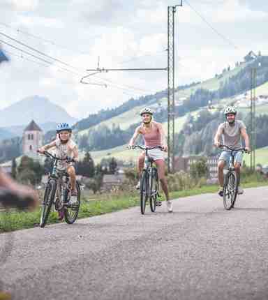 A family is cycling along a bike path