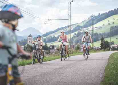 A family is cycling along a bike path