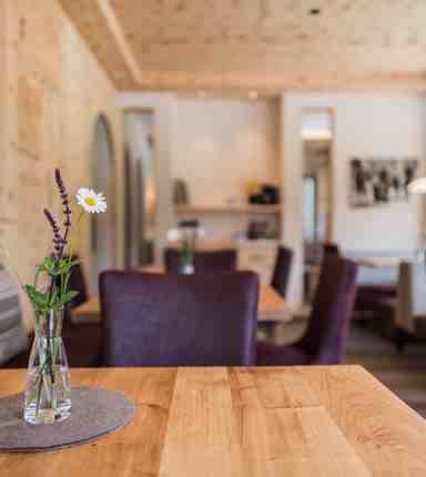 A flower vase with fresh flowers is standing on a table